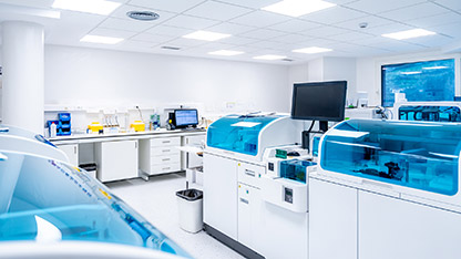 A modern laboratory filled with blue and white equipment, emphasizing a professional and sterile environment for experiments.